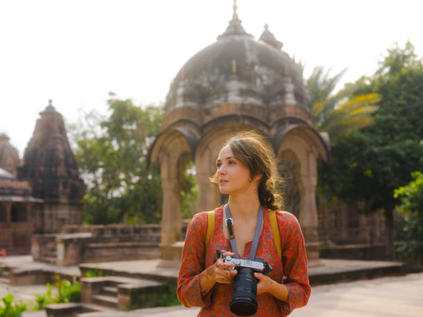 The lush Mandore Gardens, featuring historical cenotaphs, fountains, and vibrant flowerbeds, set against a clear sky.