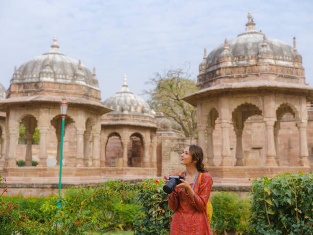 The lush Mandore Gardens, featuring historical cenotaphs, fountains, and vibrant flowerbeds, Explore Jodhpur with the Best Cab Service set against a clear sky.