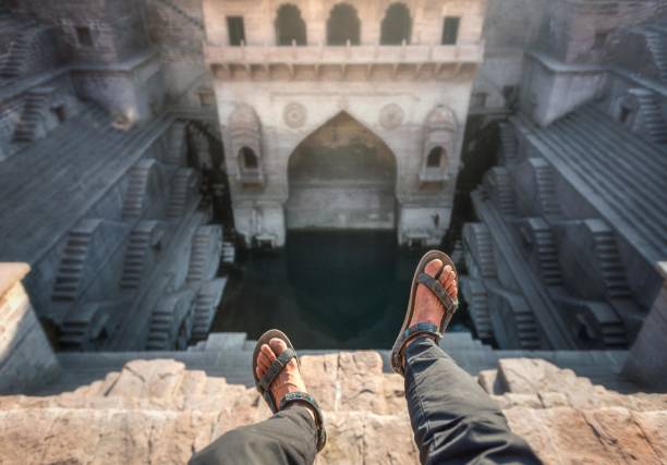 The ancient stepwell of Toorji Ka Jhalra surrounded by vibrant local architecture and visitors enjoying the serene atmosphere Explore Jodhpur with the Best Cab Service.