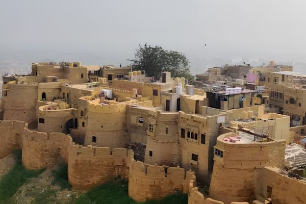 Aerial view of Jaisalmer Fort with golden sandstone buildings and historic architecture in Rajasthan.