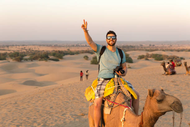 Embark on a traditional camel safari across Jaisalmer's golden sand dunes.