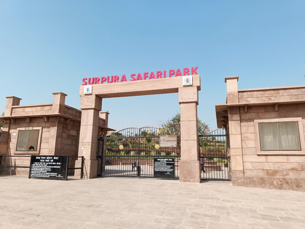 Surpura Safari Park entrance gate near Jodhpur, featuring sandstone architecture, landscaped gardens, and the main entry to a popular wildlife and nature destination.