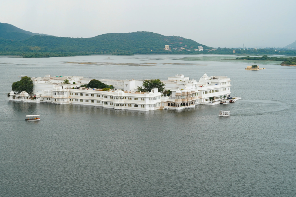 Taj Lake Palace Udaipur in Monsoon floating on Lake Pichola surrounded by soft rain and mist