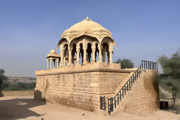 Bus Rental Jodhpur to Jaisalmer tourists exploring the royal cenotaphs of Bada Bagh
