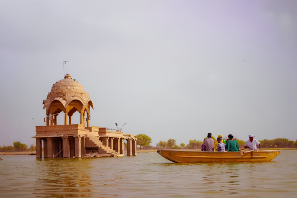 Bus Rental Jodhpur to Jaisalmer travelers enjoying the scenic beauty of Gadisar Lake