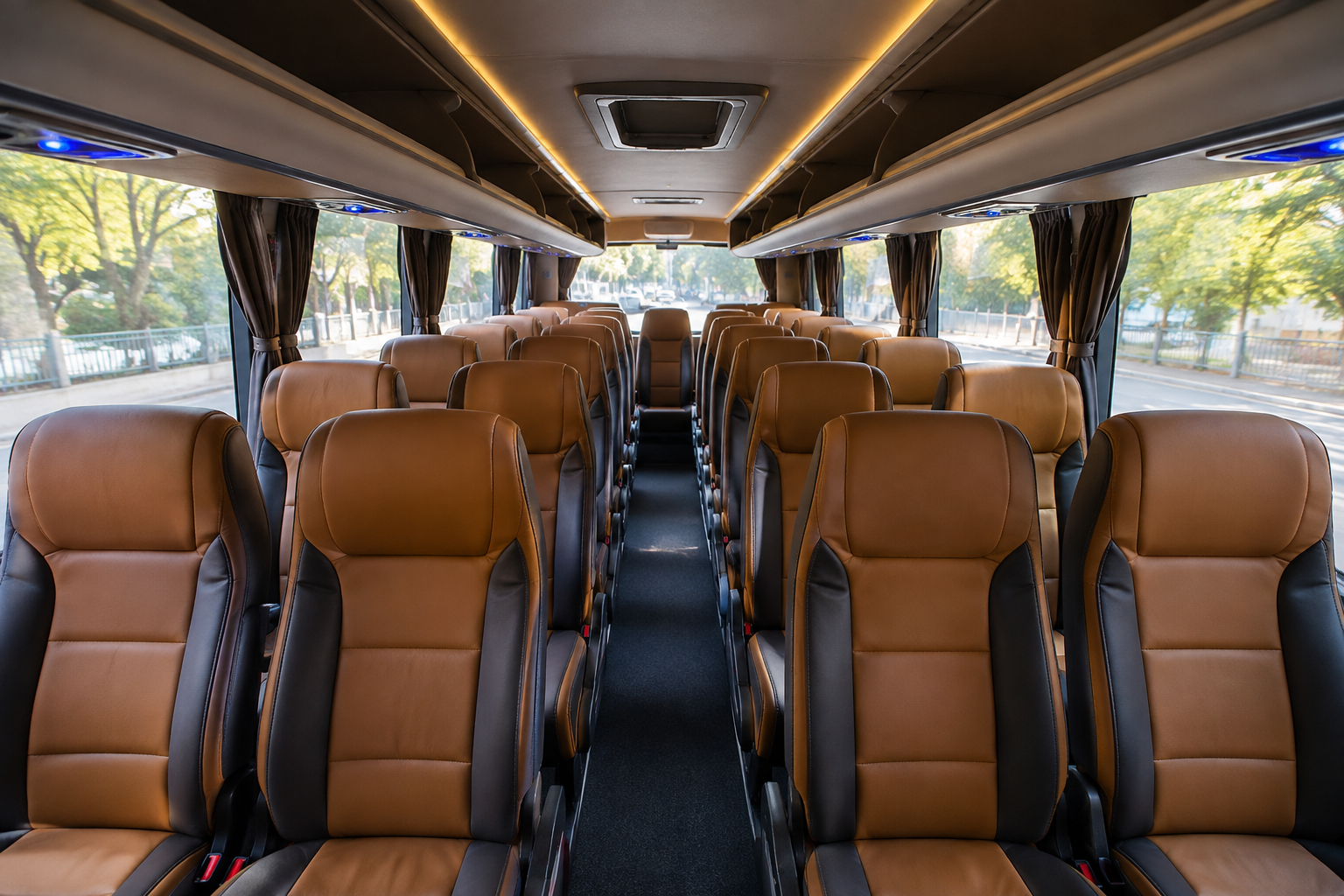 Luxury bus interior with comfortable reclining seats.