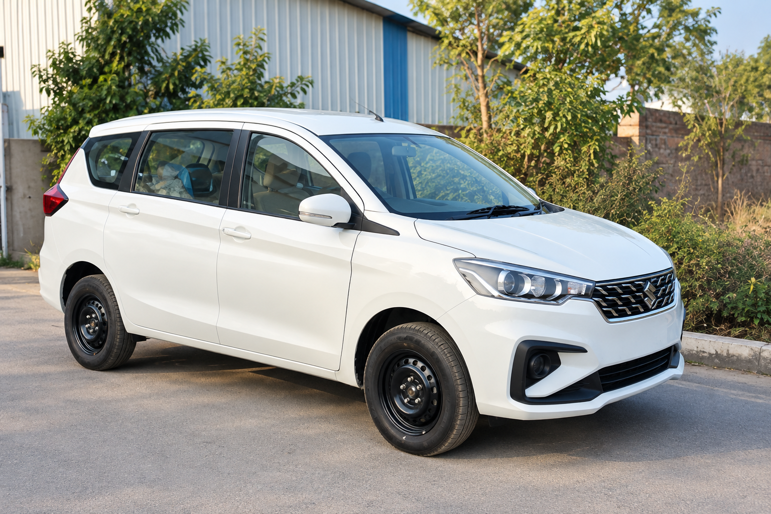 White MPV car parked outside in a front three-quarter view.