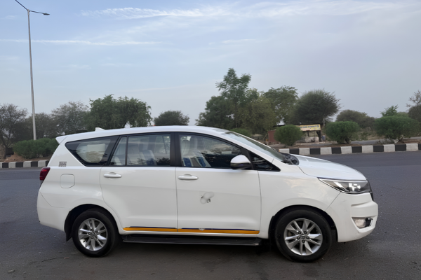 White Toyota Innova Crysta available for comfortable travel and sightseeing.