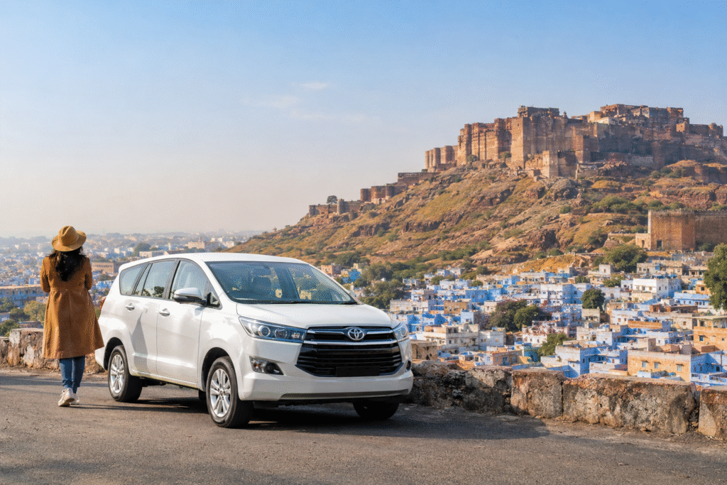 White SUV parked near Mehrangarh Fort overlooking Jodhpur’s Blue City during winter.