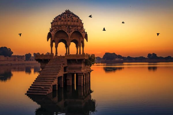 Gadisar Lake in Jaisalmer surrounded by temples and tranquil waters.